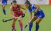 Indian forward Lalremsiami (in blue) vies for the ball with a Japanese player during Women's Hockey 