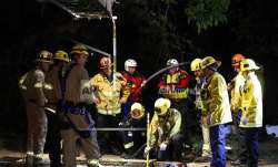 Firefighters search for a 13-year-old boy in a hole near